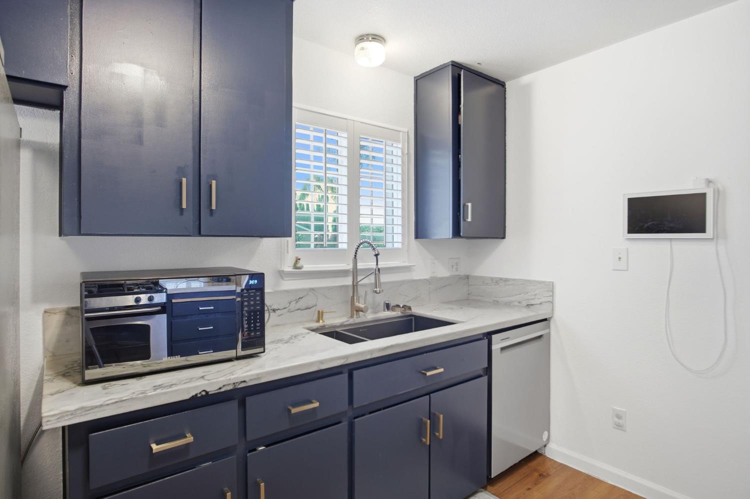1308 Basil Court Newman, CA 95360 - Photo 6 of 20 a kitchen with a sink and a microwave