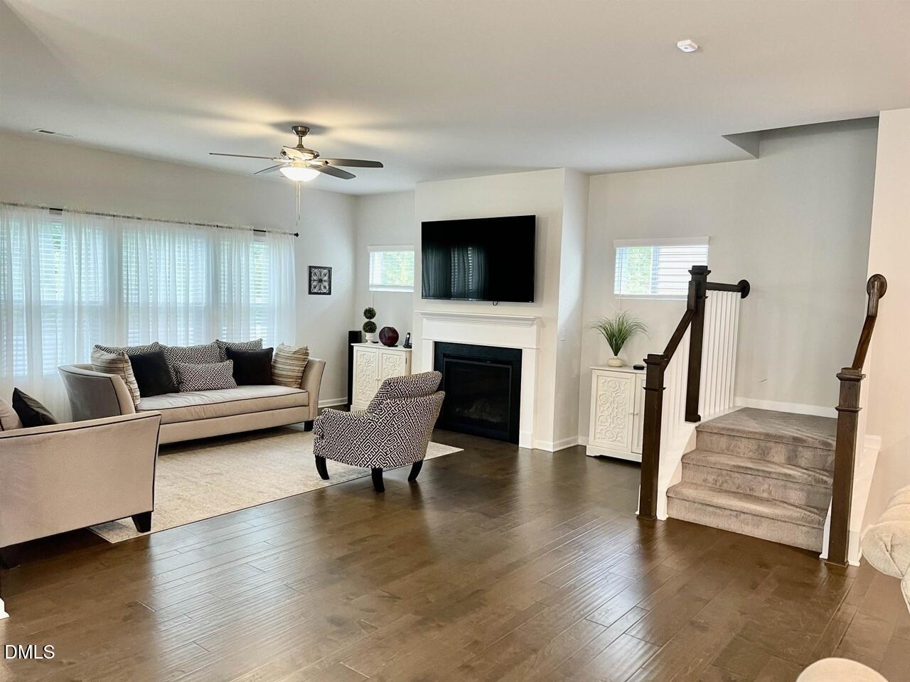 1807 Wrenn Road Durham, NC 27703 - Photo 3 of 43 a living room with furniture a flat screen tv and a fireplace