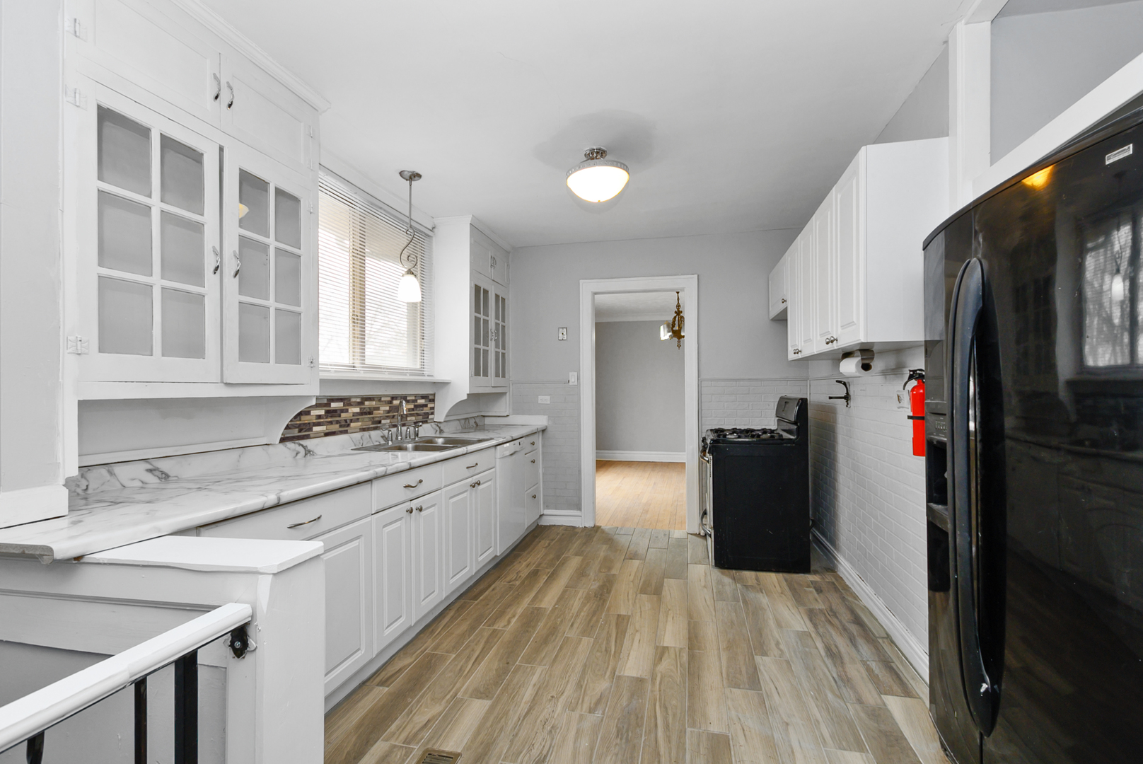 14823 Grant Street Dolton, IL 60419 - Photo 13 of 37 a kitchen with a refrigerator and a sink