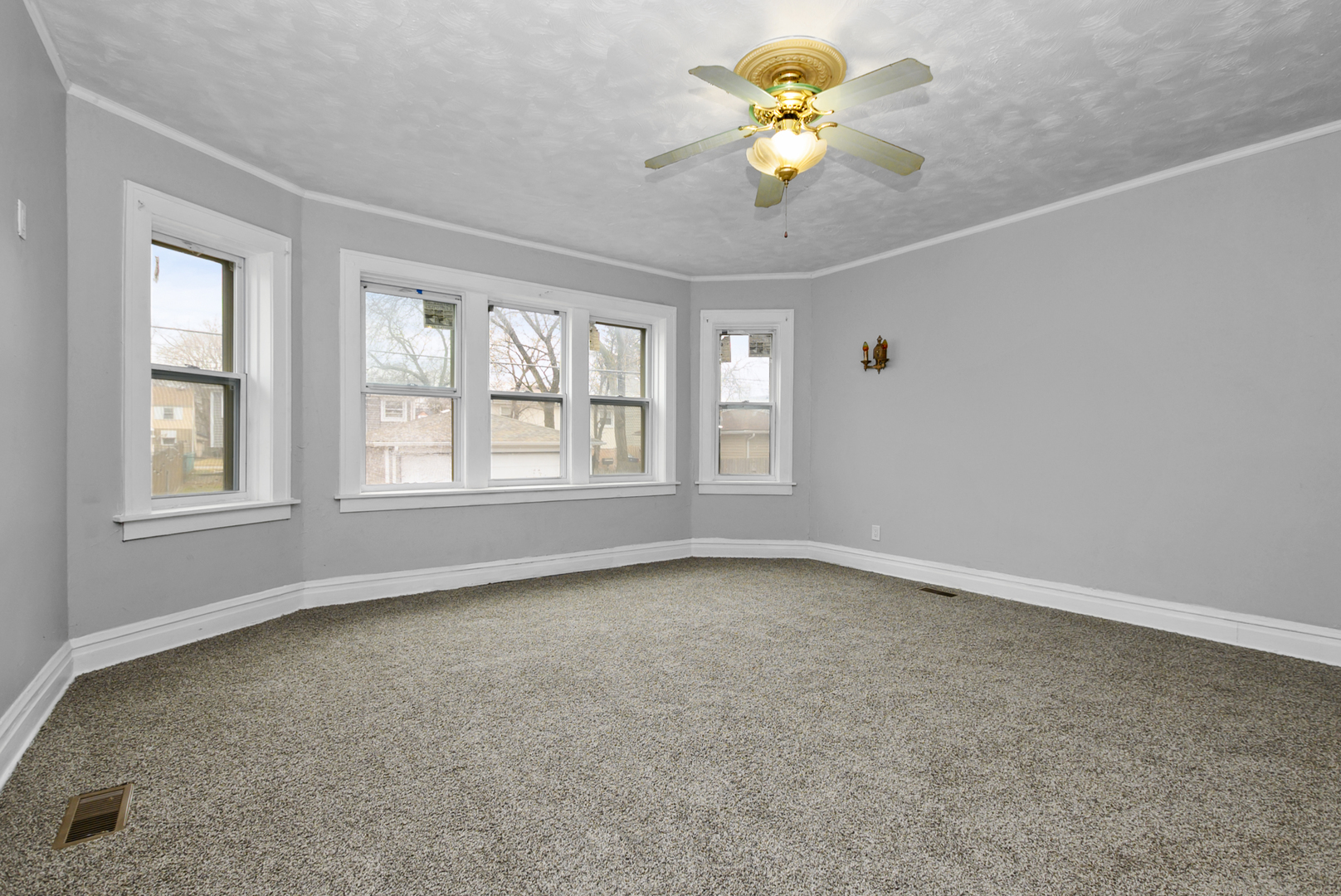 14823 Grant Street Dolton, IL 60419 - Photo 25 of 37 an empty room with a window and a chandelier fan