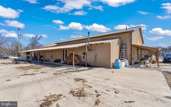 a view of a dry yard with wooden fence