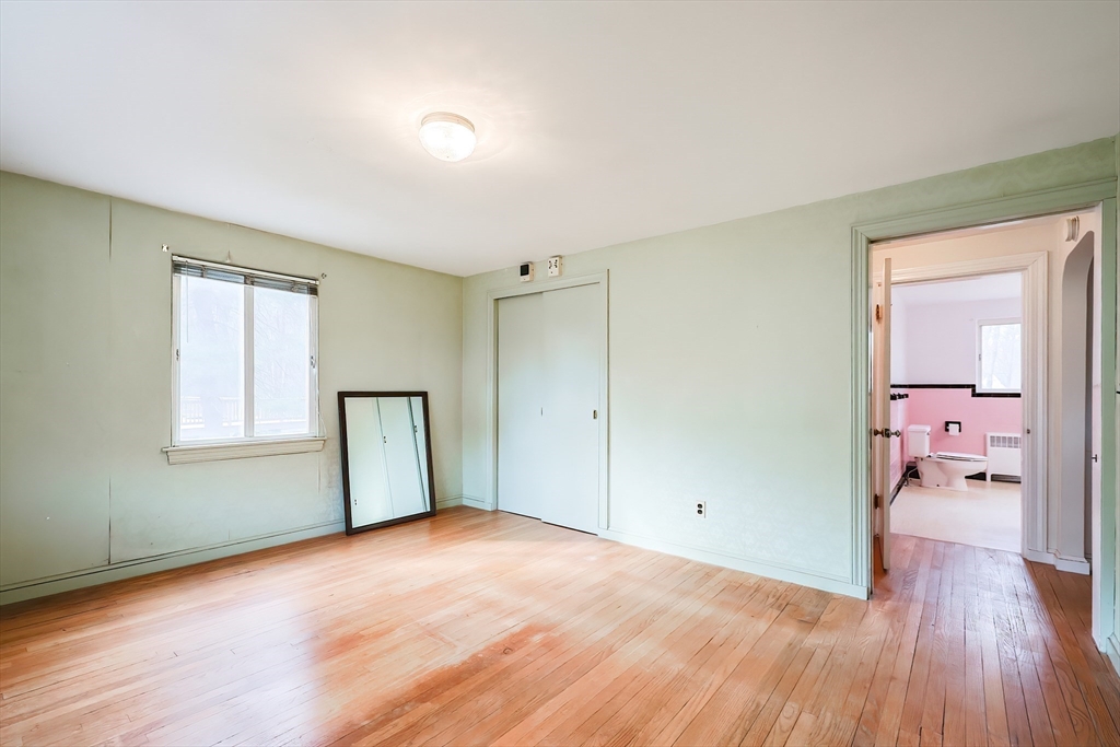 58 Cutler Drive Framingham, MA 01702 - Photo 19 of 35 a view of empty room with wooden floor and a window