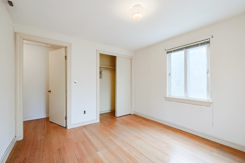 58 Cutler Drive Framingham, MA 01702 - Photo 20 of 35 an empty room with wooden floor and windows