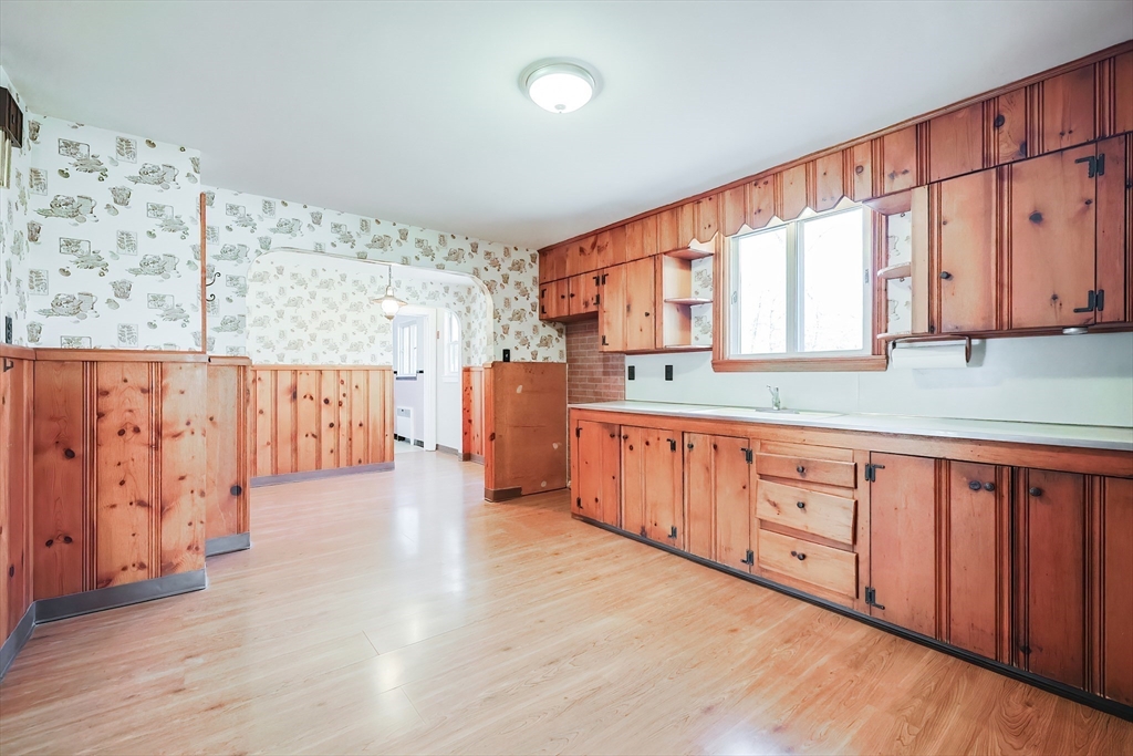 58 Cutler Drive Framingham, MA 01702 - Photo 6 of 35 a large kitchen with stainless steel appliances wooden cabinets a sink and a window