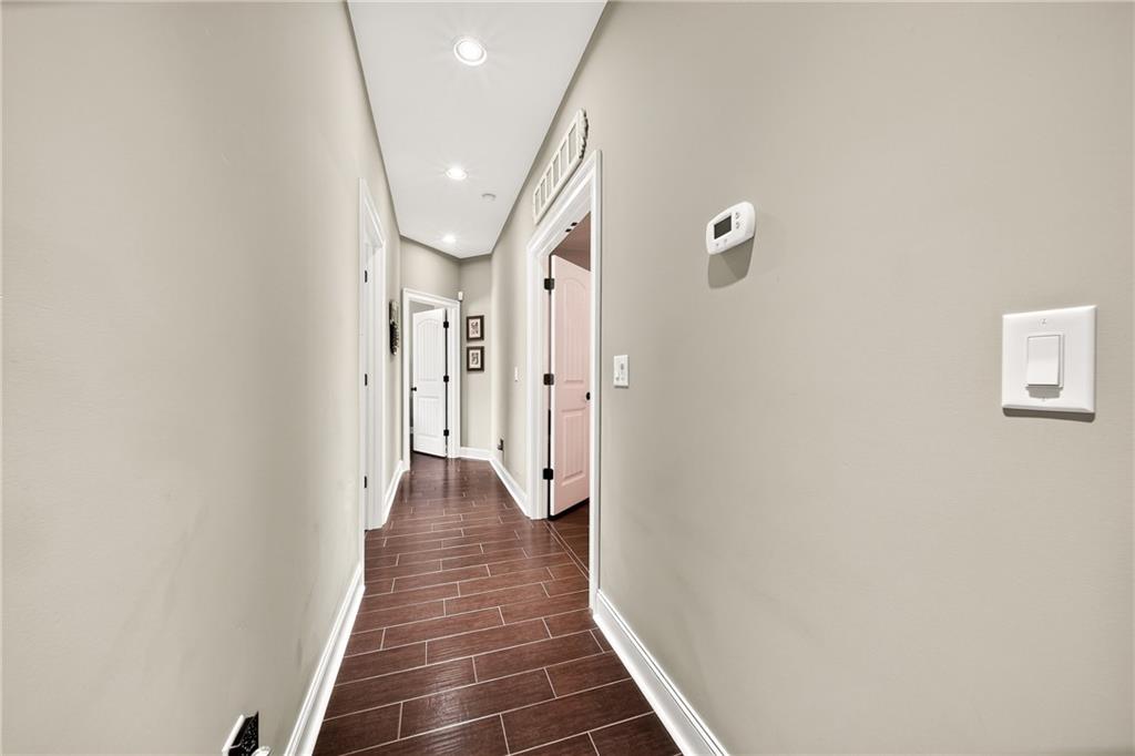 611 Padgetts Road Opelika, AL 36804 - Photo 25 of 64 Recessed ceiling lights illuminate the hallway featuring wood-finish flooring and white trim