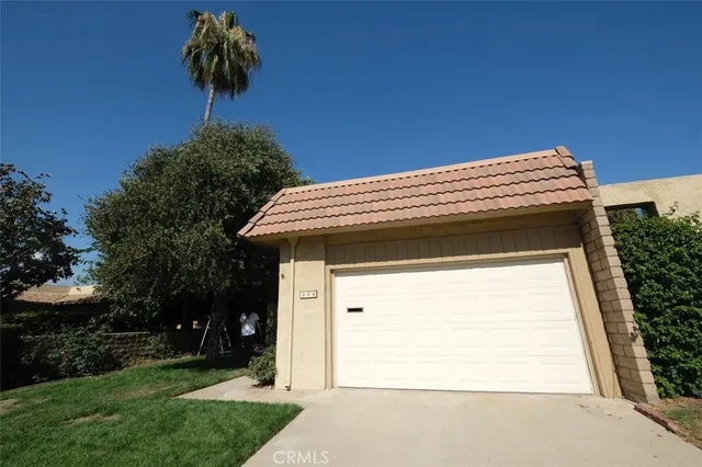 a view of a house with a small yard and a large window