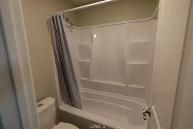 a white toilet sitting next to a bathroom sink