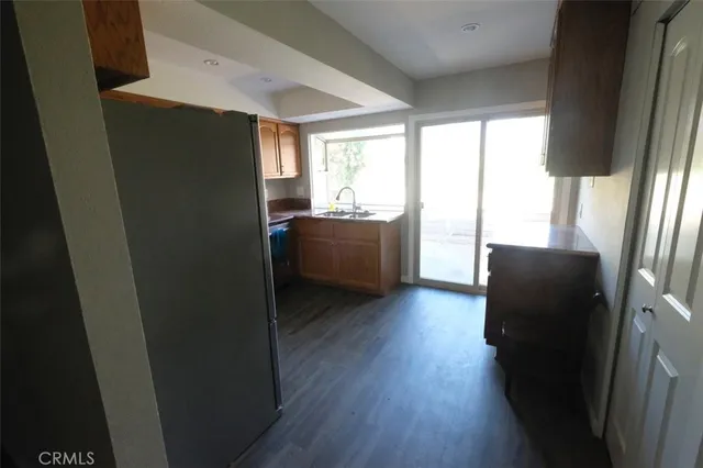 a kitchen with granite countertop stainless steel appliances a stove top oven and sink