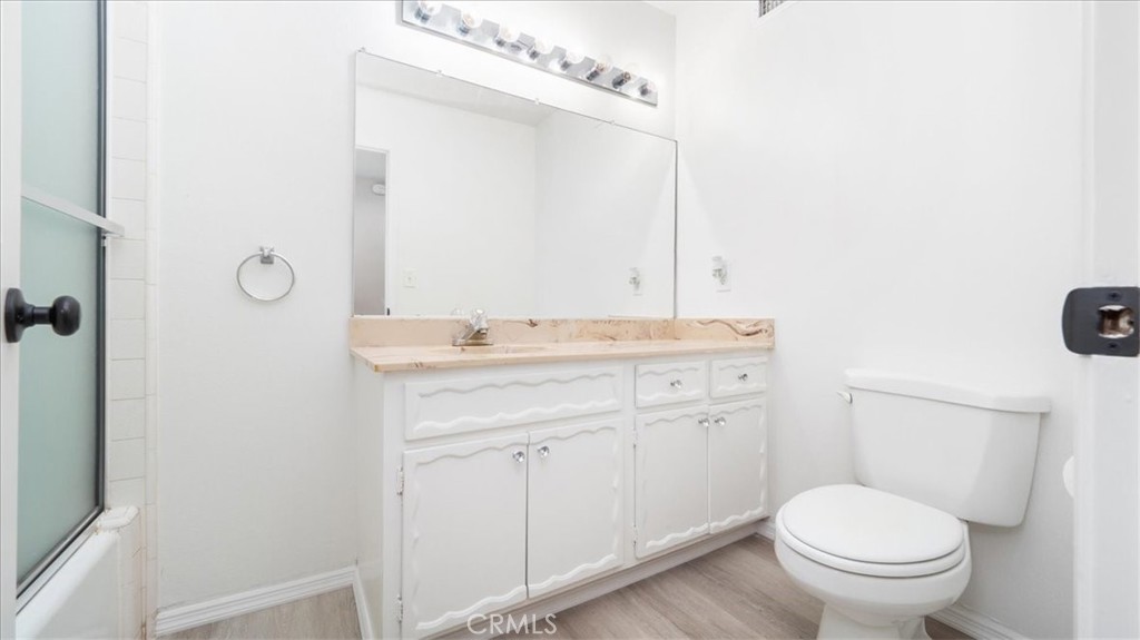 1607 Temescal Avenue Norco, CA 92860 - Photo 11 of 20 a bathroom with a granite countertop toilet sink and mirror
