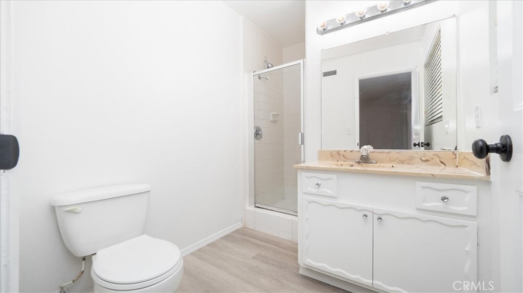 1607 Temescal Avenue Norco, CA 92860 - Photo 12 of 20 a bathroom with a toilet a sink and mirror