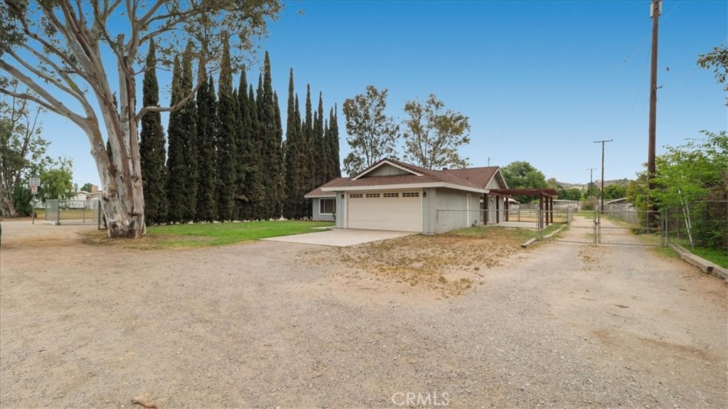 1607 Temescal Avenue Norco, CA 92860 - Photo 2 of 20 a front view of a house with a yard and garage