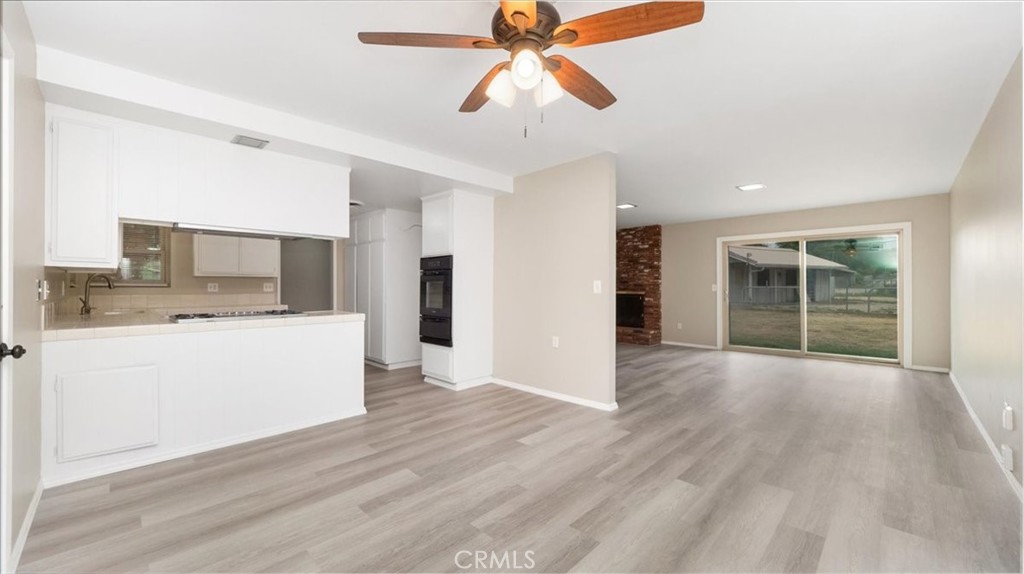 1607 Temescal Avenue Norco, CA 92860 - Photo 5 of 20 a view of an empty room with wooden floor and a kitchen