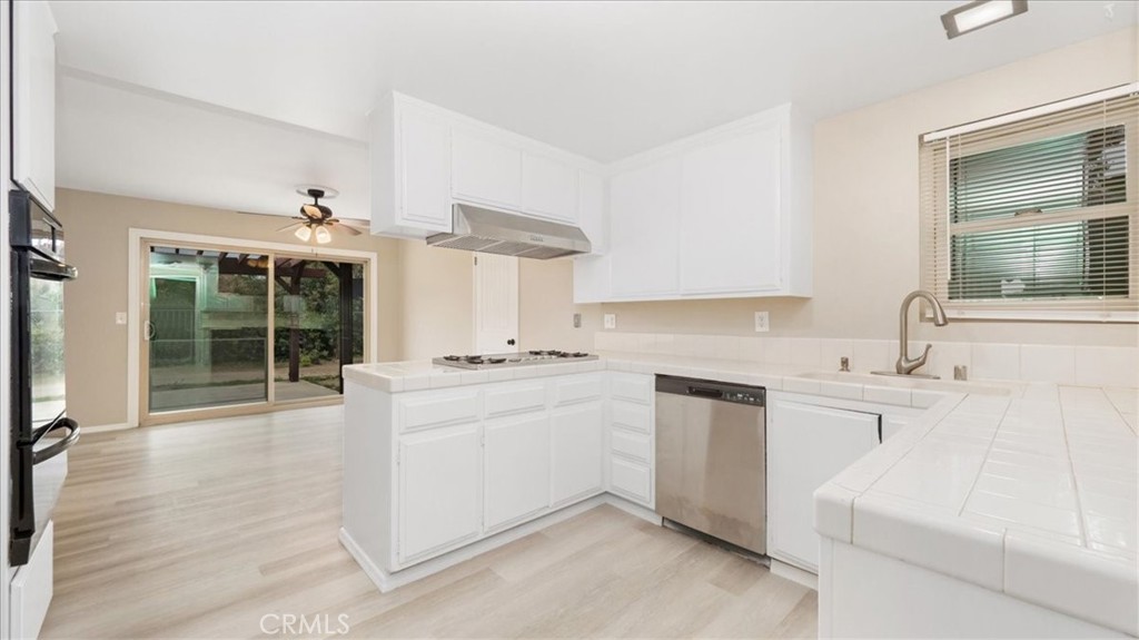 1607 Temescal Avenue Norco, CA 92860 - Photo 7 of 20 a kitchen with a sink stove and cabinets