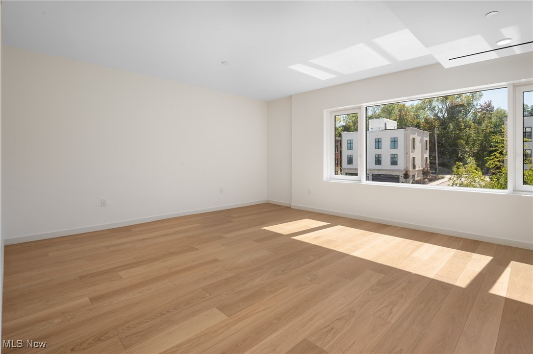 22700 Lake Road, Unit 306 Rocky River, OH 44116 - Photo 12 of 28 Spare room with light wood finished floors and a skylight