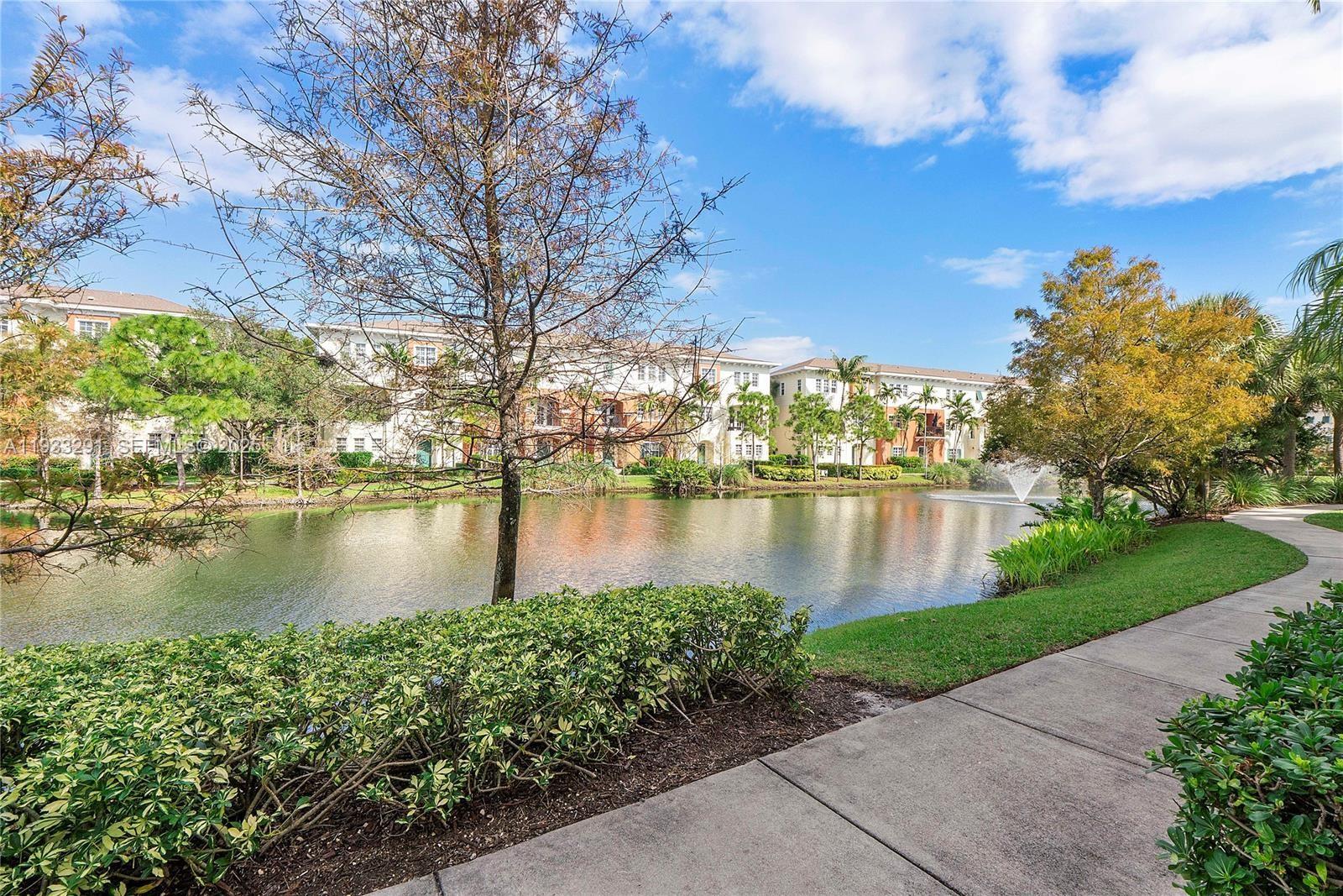 218 Southwest 6th Place Pompano Beach, FL 33060 - Photo 28 of 28 serene sidewalk views around lake.