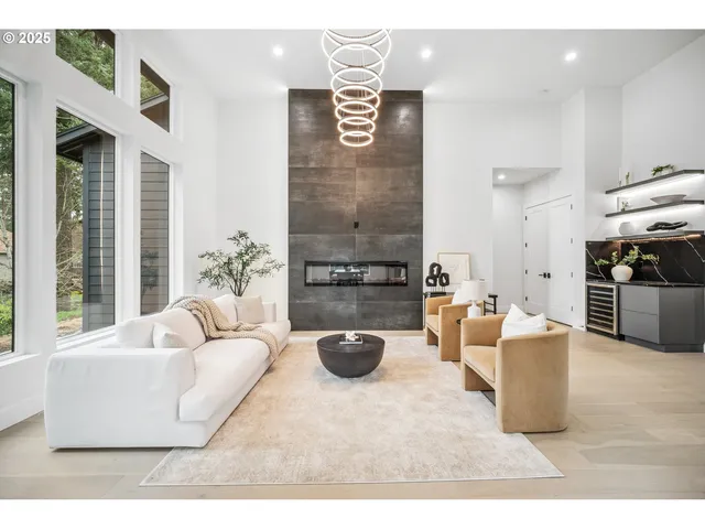 a living room with furniture a chandelier and a couch