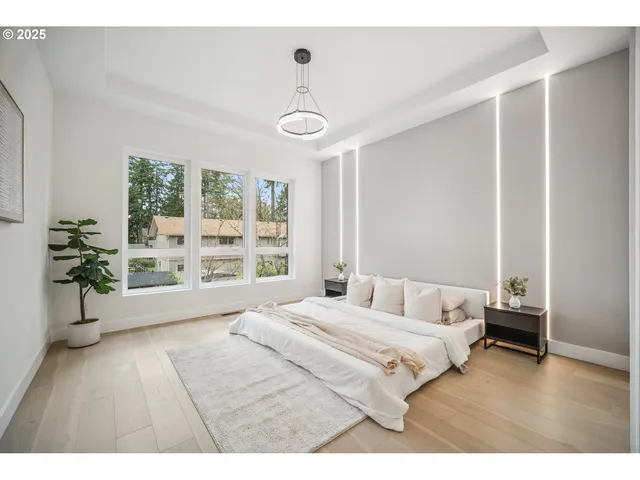 a bedroom with a large bed and a window