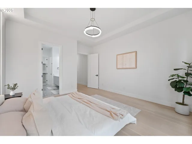 a bedroom with a bed and a chandelier