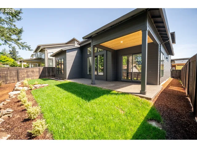 a view of a house with a yard and porch