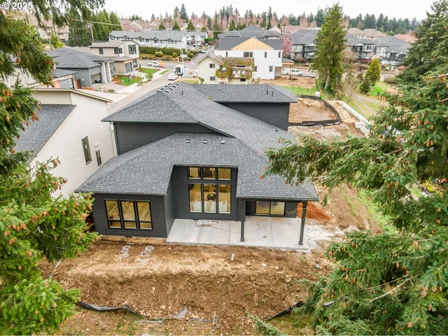an aerial view of a house with a yard