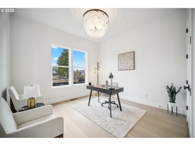 a living room with furniture a window and a table