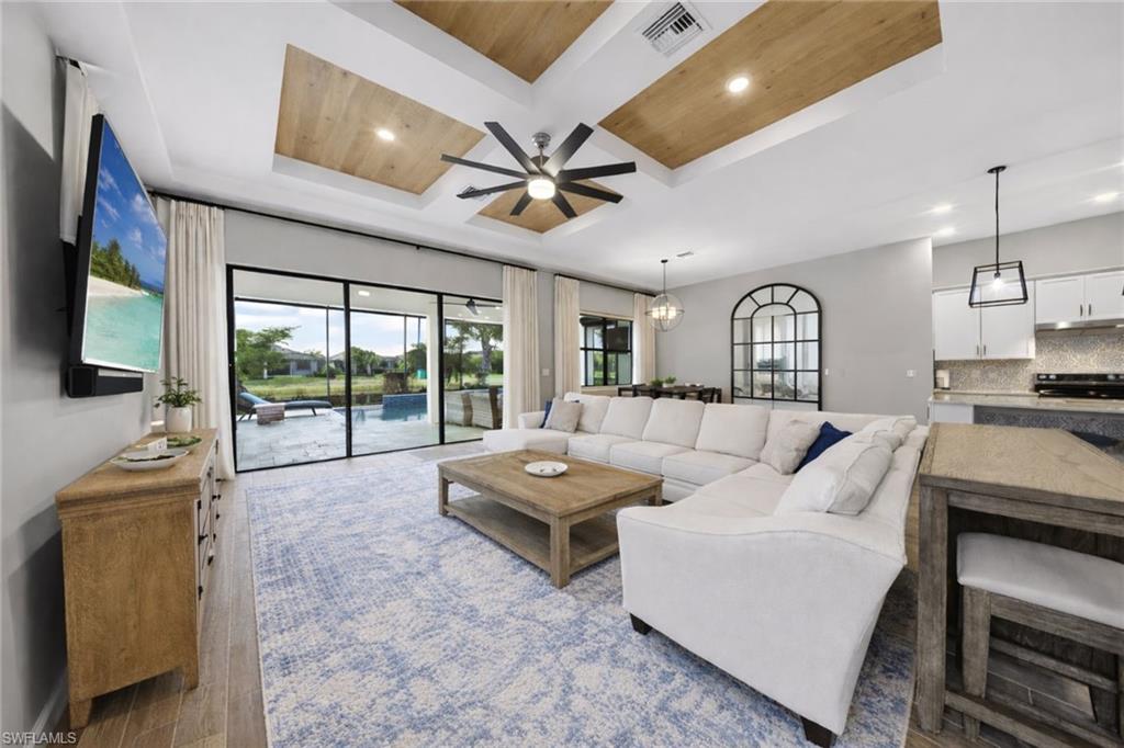 11920 Bourke Place Fort Myers, FL 33913 - Photo 2 of 45 a living room with furniture and a flat screen tv