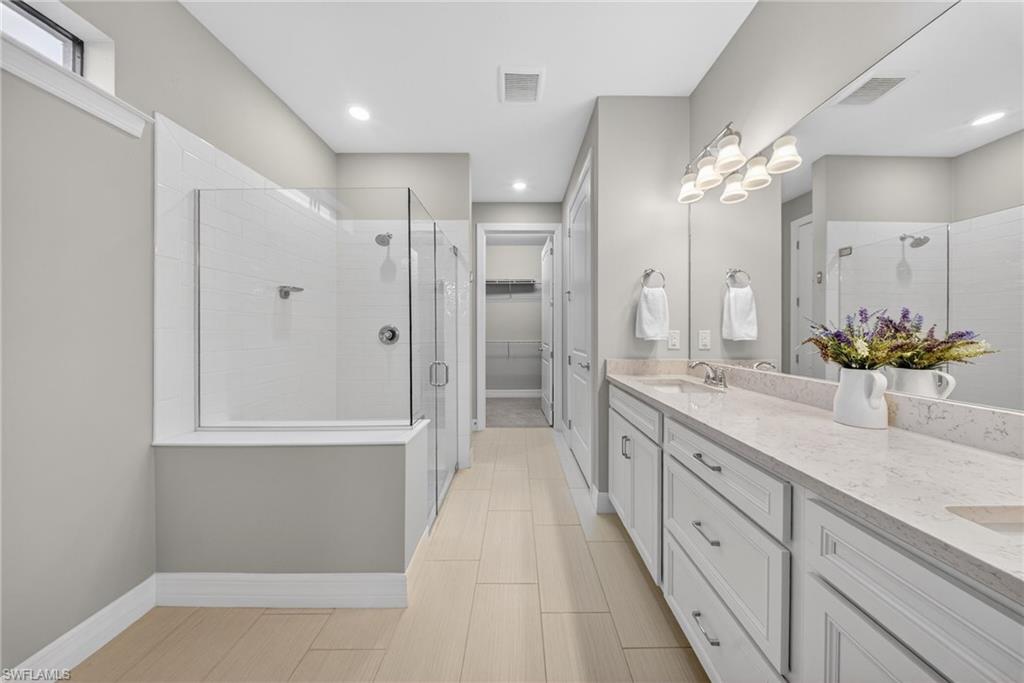 11920 Bourke Place Fort Myers, FL 33913 - Photo 21 of 45 a bathroom with a double vanity sink and a mirror