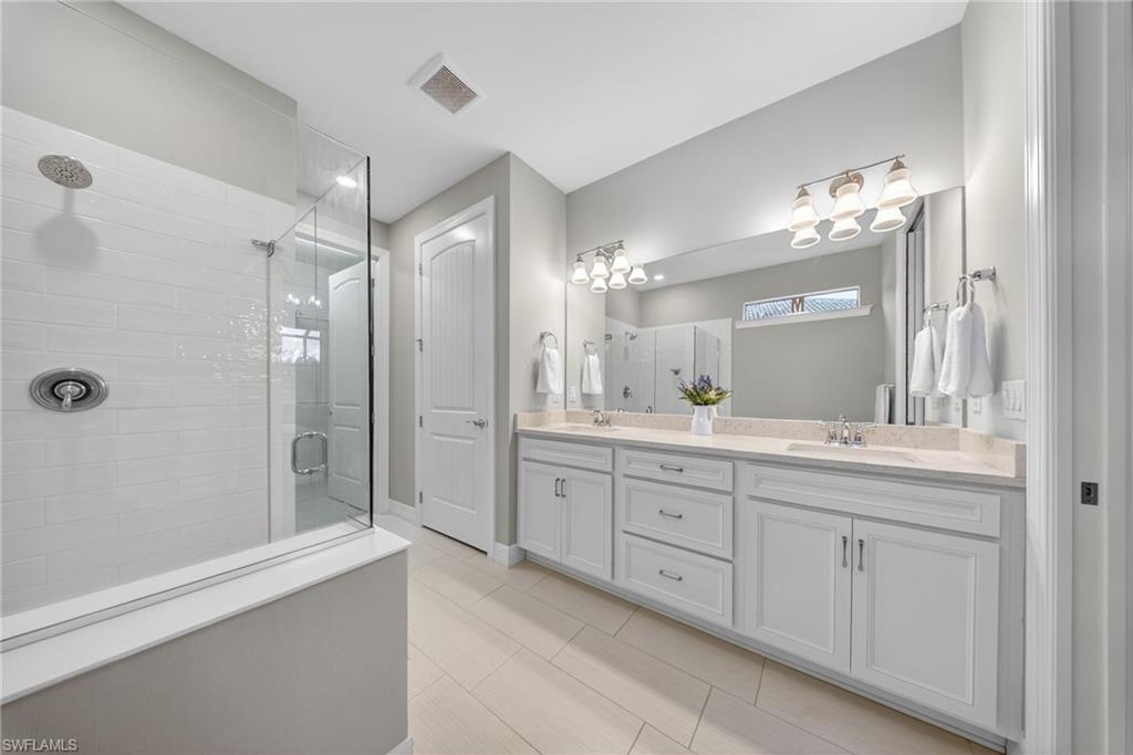 11920 Bourke Place Fort Myers, FL 33913 - Photo 22 of 45 a bathroom with a double vanity sink mirror and shower