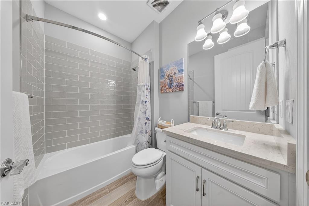 11920 Bourke Place Fort Myers, FL 33913 - Photo 28 of 45 a bathroom with a granite countertop sink toilet a mirror and shower