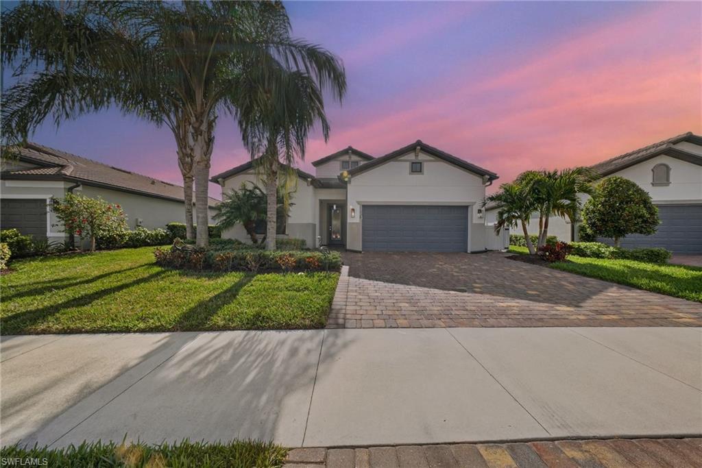 11920 Bourke Place Fort Myers, FL 33913 - Photo 32 of 45 a front view of a house with a yard and garage