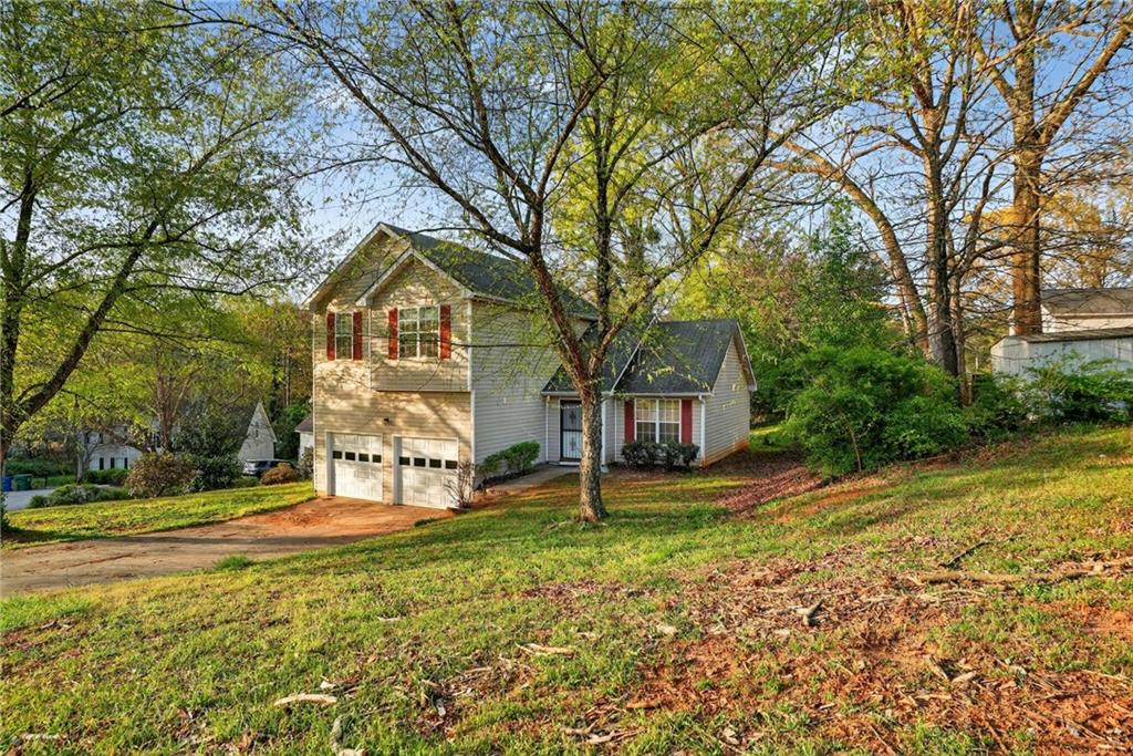a view of a house with a large tree and a big yard