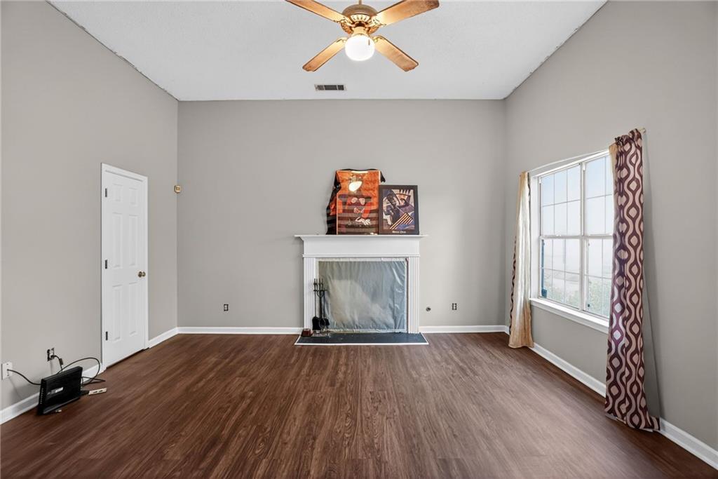 3429 Sumter Place Decatur, GA 30034 - Photo 14 of 30 an empty room with wooden floor fan and windows