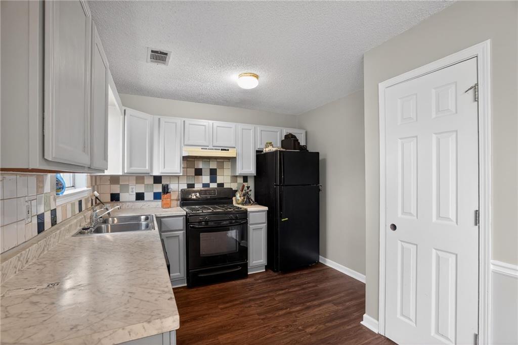 3429 Sumter Place Decatur, GA 30034 - Photo 20 of 30 a kitchen with granite countertop a refrigerator stove and sink