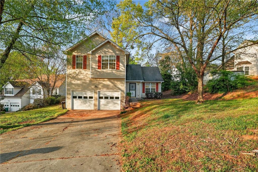 3429 Sumter Place Decatur, GA 30034 - Photo 2 of 30 a front view of a house with a yard and garage