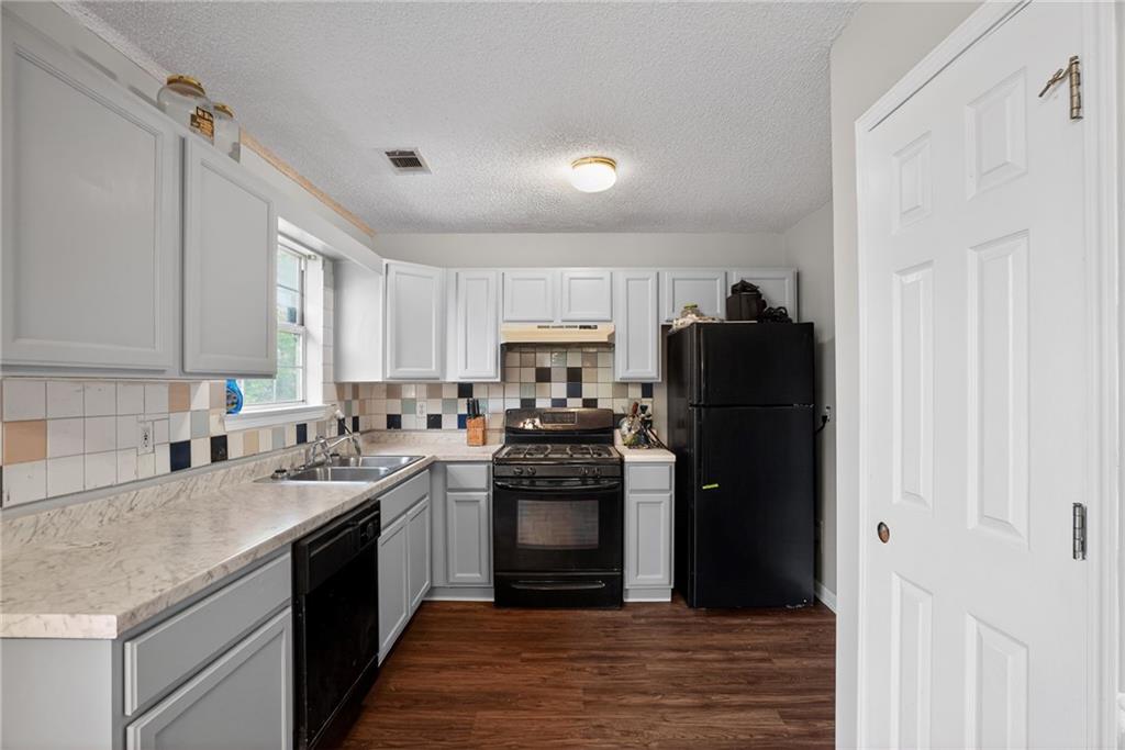 3429 Sumter Place Decatur, GA 30034 - Photo 21 of 30 a kitchen with a sink dishwasher a refrigerator and a stove
