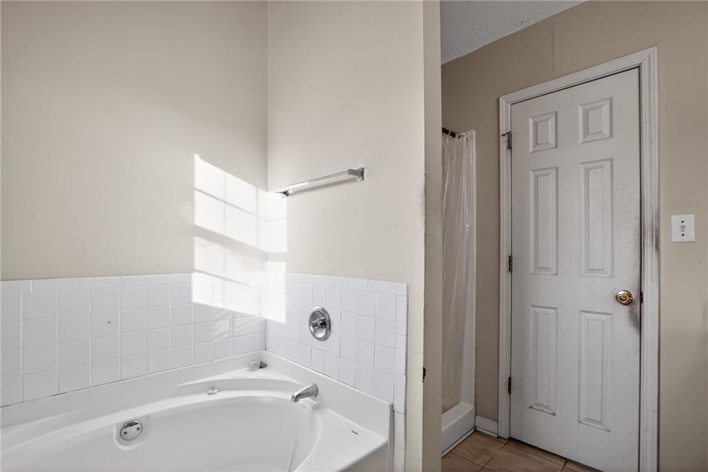 3429 Sumter Place Decatur, GA 30034 - Photo 28 of 30 a bathroom with a tub a sink and a window