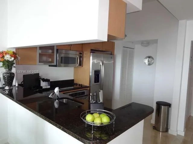 a kitchen with a sink appliances and cabinets