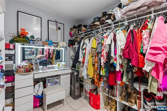 a view of walk in closet with clothes