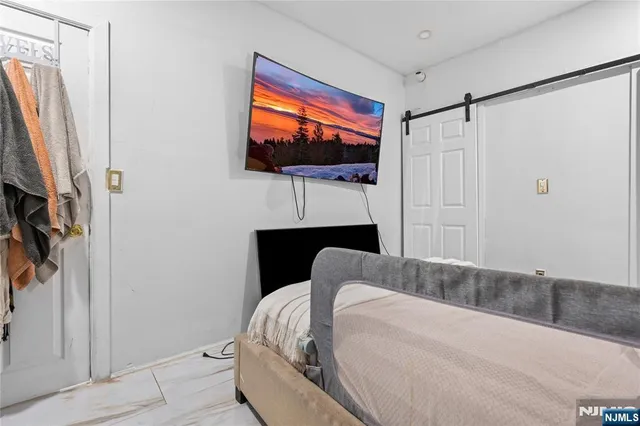 a living room with a flat screen tv and a white door