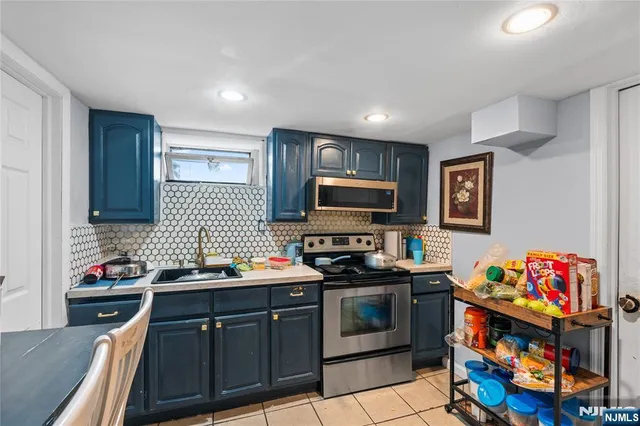 a kitchen with stainless steel appliances stove top oven and cabinets