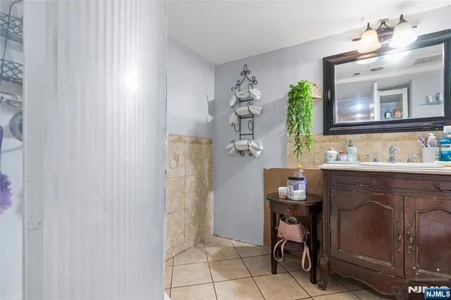a bathroom with a sink a mirror and a shower