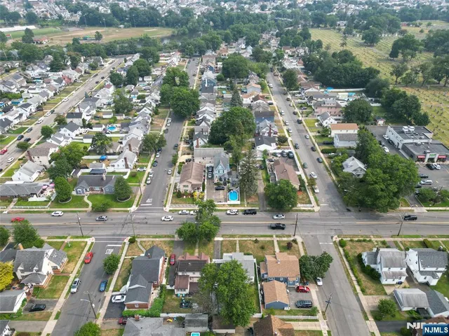 an aerial view of residential houses with outdoor space and lake view