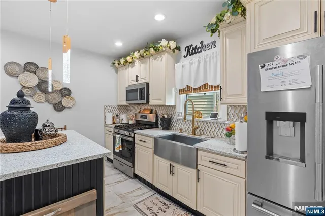 a kitchen with a sink cabinets and appliances
