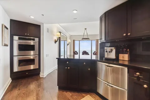 a kitchen with granite countertop a refrigerator and a stove