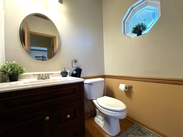 a bathroom with a toilet a sink and mirror
