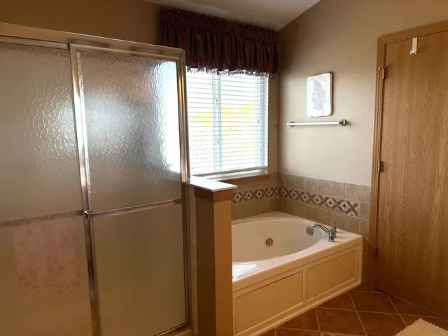 a bathroom with a bathtub and a shower