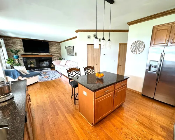 a kitchen with stainless steel appliances granite countertop a stove a refrigerator and a microwave