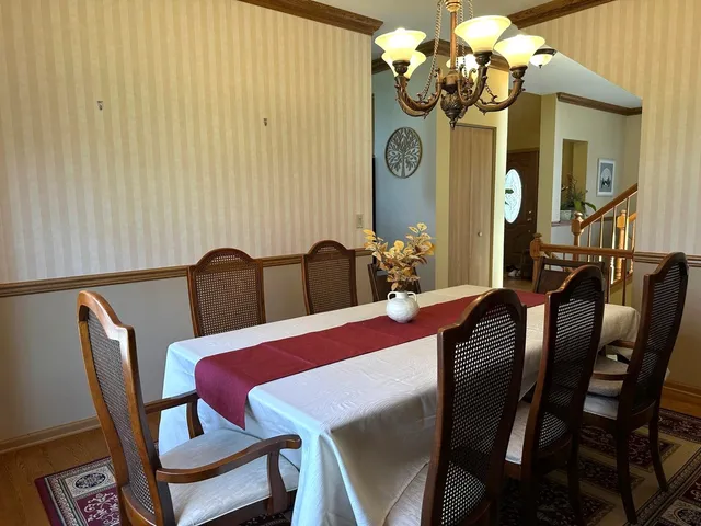 a view of a dining room with furniture and a chandelier