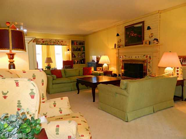 327 Traceway Road High Point, NC 27265 - Photo 3 of 16 Living Room. Living room features wood burning fireplace, crown moulding and chair railing