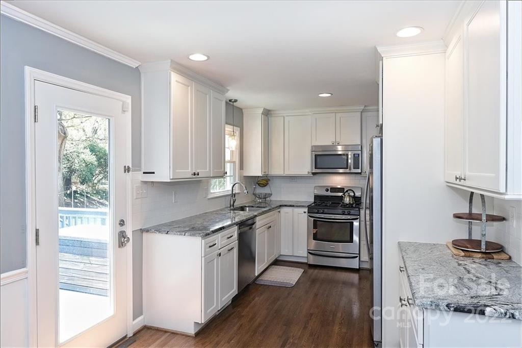 3616 Round Oak Road Charlotte, NC 28210 - Photo 12 of 48 a kitchen with stainless steel appliances granite countertop a stove a sink and a refrigerator